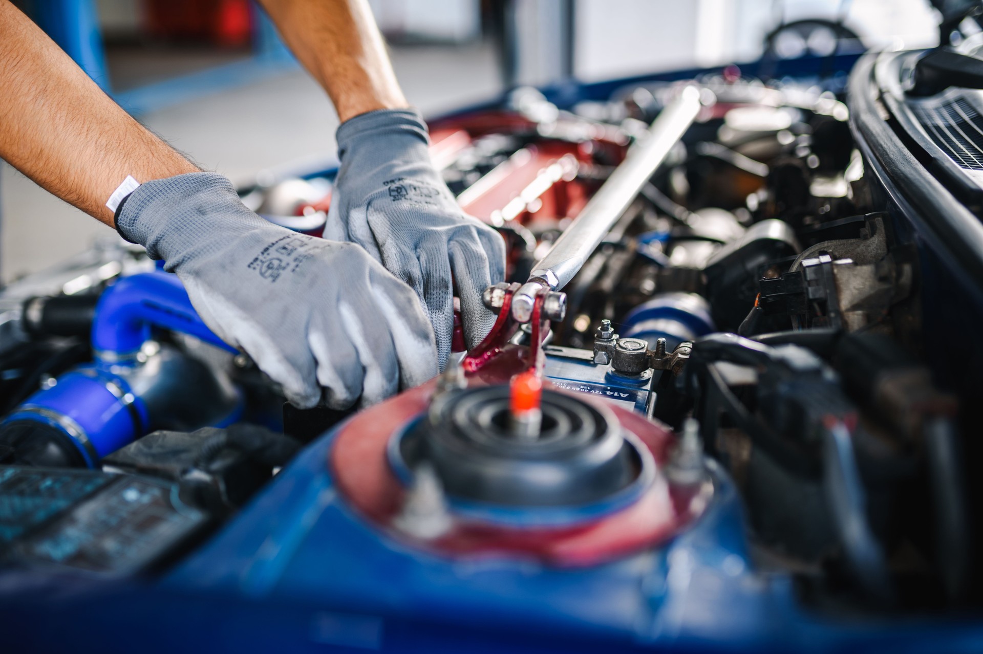 Auto mechanic analyzing engine problems while working in a workshop